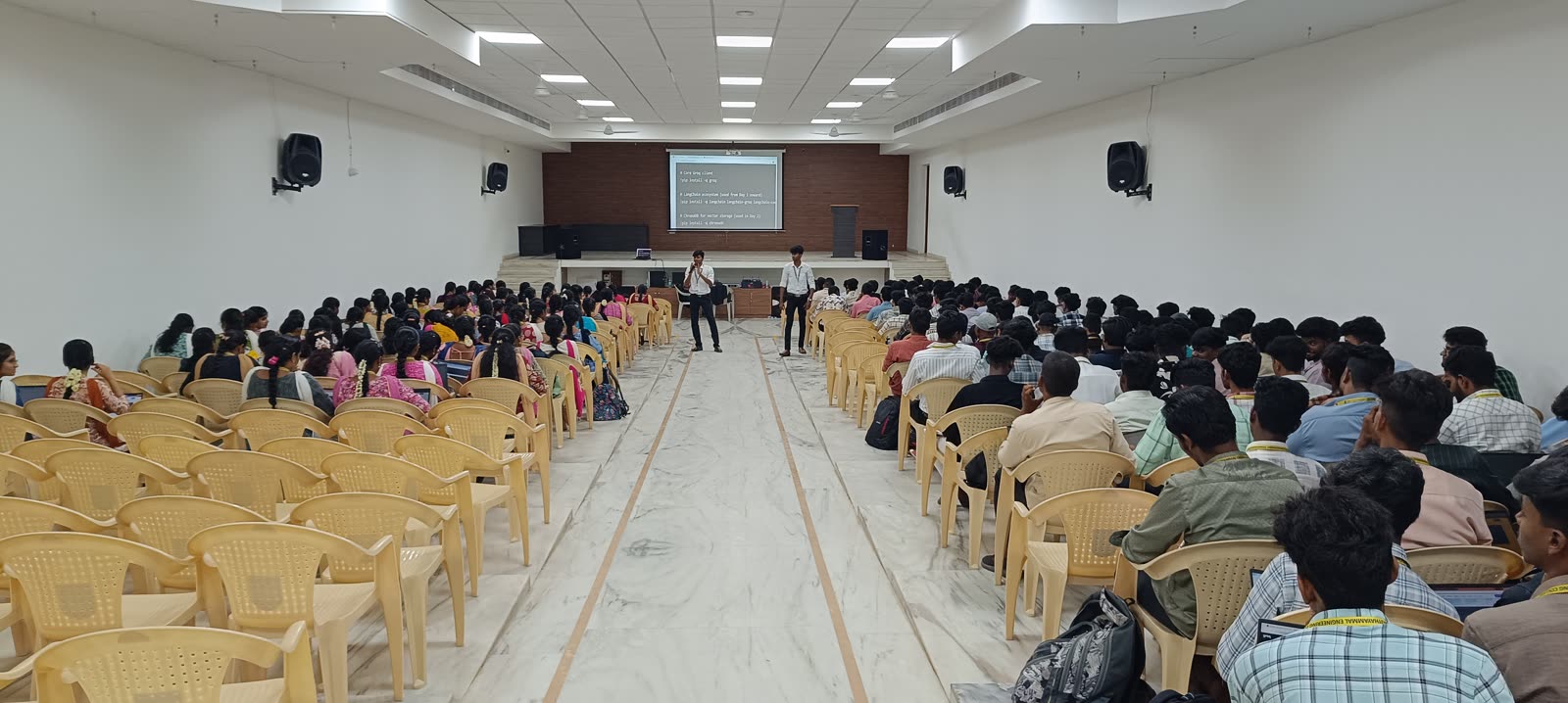 A full auditorium of students at a GeekBase campus programming workshop